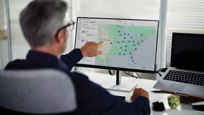 A man looking at a computer display showing Carrier's Lynx Fleet Next Generation software.