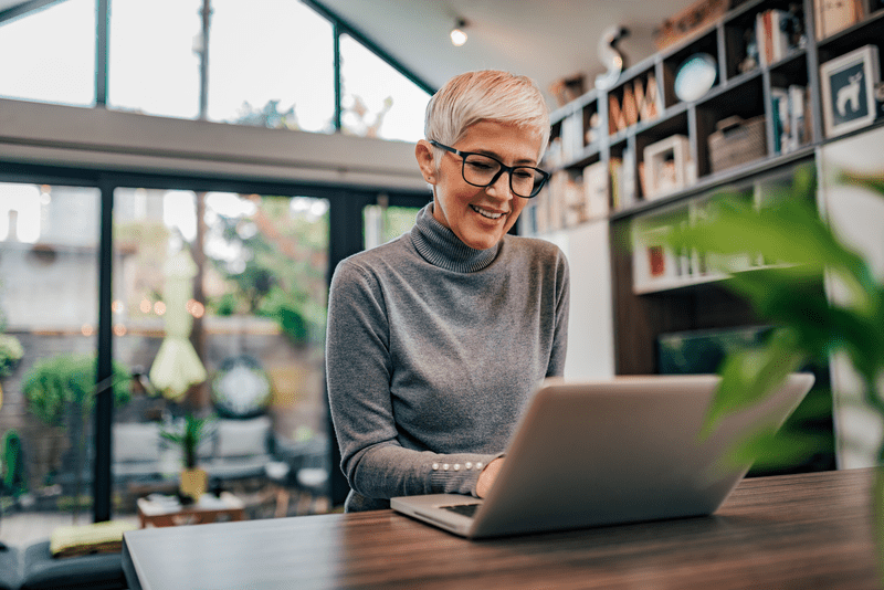 A woman searching warranty information on her laptop.