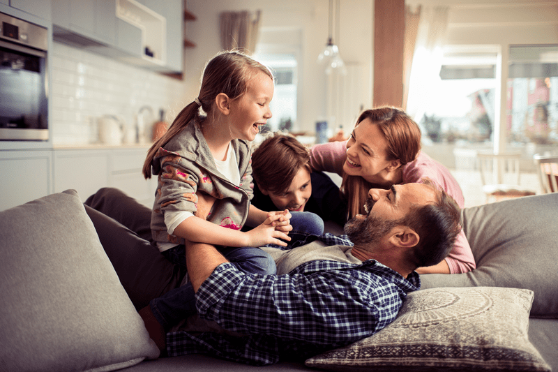 Family in house on couch playing